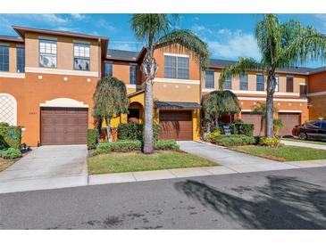 Attractive townhome with a two-car garage and landscaped front yard at 30129 Mossbank Dr, Wesley Chapel, FL 33543