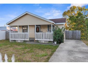 Charming yellow house with a porch and a small yard at 3436 51St N Ave, St Petersburg, FL 33714