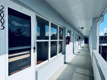 Apartment building hallway with light-colored walls and several apartment doors at 4300 58Th N St # 2005, Kenneth City, FL 33709