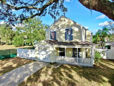 Two-story house with a garage and picket fence at 8211 Volusia Pl, Tampa, FL 33637