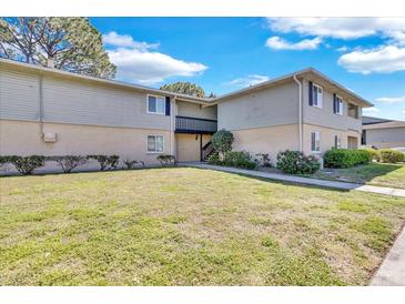 Exterior view of building showcasing landscaping and outdoor stairway at 209 Red Cedar Pl # 209, Brandon, FL 33510