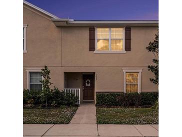 Well-maintained townhouse exterior with a walkway and landscaping at 5025 Cactus Needle Ln, Wesley Chapel, FL 33544
