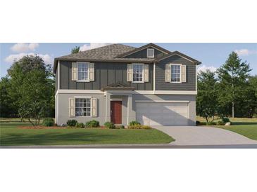 Two-story home with gray siding, red door, and attached garage at 3752 Capital Reserve Dr, Plant City, FL 33565