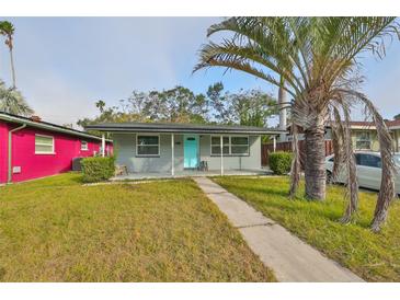 Gray house with teal door, walkway, and palm tree at 5117 12Th S Ave, Gulfport, FL 33707