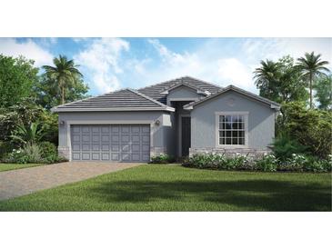 Single-story home with gray siding, tile roof, and landscaped lawn at 10615 Sun Drop St, Venice, FL 34293