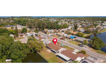 Aerial view of a single-Gathering home with water access at 3438 Moog Rd, Holiday, FL 34691
