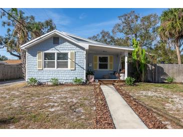 Charming bungalow with light blue siding, yellow shutters, and a porch swing at 420 40Th N St, St Petersburg, FL 33713