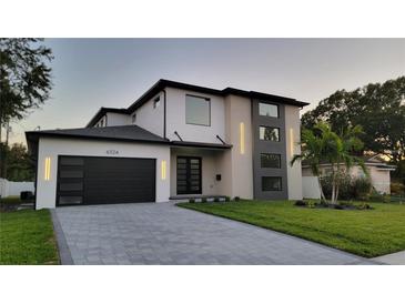 Two-story modern home with dark gray garage doors and stylish lighting at 6524 6Th N Ave, St Petersburg, FL 33710