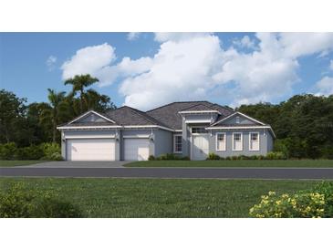 Two-story home with three-car garage and landscaped yard at 8562 Shore Lake Dr, Englewood, FL 34224