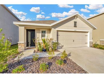Attractive one-story home with a two-car garage and landscaped front yard at 1663 Hazy Sea Dr, Plant City, FL 33565