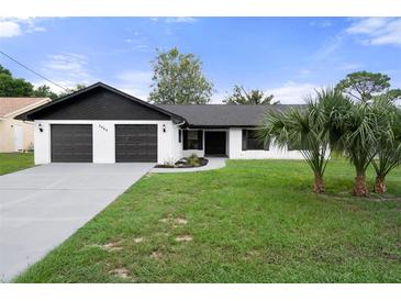 Newly renovated home with modern two-car garage and curb appeal at 2464 Keeport Dr, Spring Hill, FL 34609