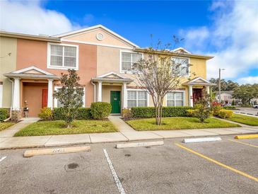 Two-story townhome with attractive landscaping and parking at 30405 Elderwood Dr, Wesley Chapel, FL 33543