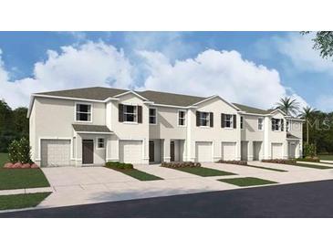 New townhome community with 3-story buildings, 2-car garages, and landscaping at 31280 Midnight Sun Way, Wesley Chapel, FL 33545