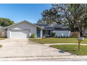 Charming single story home with attached garage and landscaped lawn at 1497 Rosetree Ct, Clearwater, FL 33764
