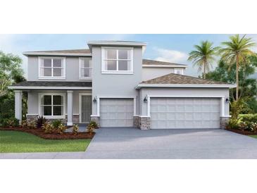 Two-story home with gray siding, stone accents, and a two-car garage at 912 160Th E Ln, Bradenton, FL 34212