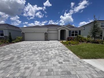 Charming single-story home boasts a paver driveway and a well-manicured lawn at 4314 Pullet Ct, Lakewood Ranch, FL 34211