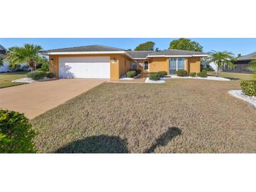 House exterior with a single-car garage and manicured landscaping at 703 Elkhorn Rd, Sun City Center, FL 33573