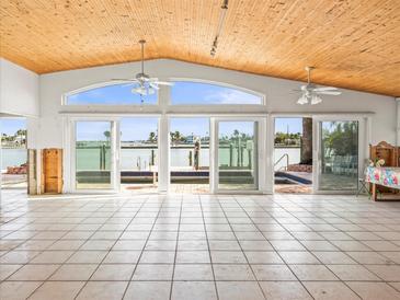 Spacious living area with vaulted ceilings, tile floors and water views at 16124 4Th E St, Redington Beach, FL 33708