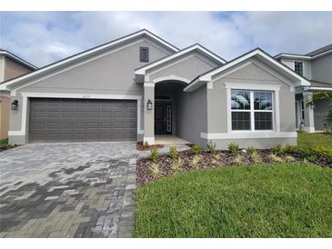 Curb appeal abounds in this charming one-story home, featuring a two-car garage and attractive landscaping at 36159 Welsh Glade Rd, Dade City, FL 33525