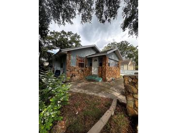 Ranch style home with stone facade and mature landscaping at 2011 Auburn S St, St Petersburg, FL 33712