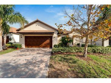 Attractive single-story home with a two-car garage and landscaped yard at 16820 Anchor Root St, Wimauma, FL 33598