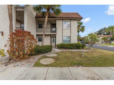 Inviting condo exterior, featuring landscaping and a private entrance at 2750 E Bay Dr # 15E, Largo, FL 33771