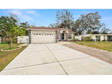 One-story house with attached garage, paver driveway, and landscaped yard at 5640 81St N Ave, Pinellas Park, FL 33781