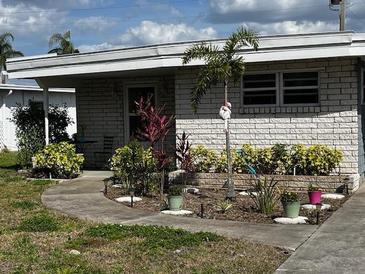 Charming single-story home with a well-maintained front yard and walkway at 72 Liberty Way # 4, Palm Harbor, FL 34684