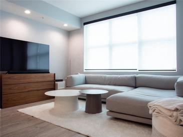 Bright living room featuring a comfortable sectional sofa, modern furniture, and large window at 1120 E Kennedy Blvd # 1225, Tampa, FL 33602