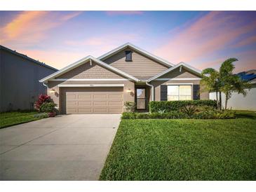 Attractive one-story house with a two-car garage and well-manicured lawn at 7963 Sail Clover Ln, Zephyrhills, FL 33540