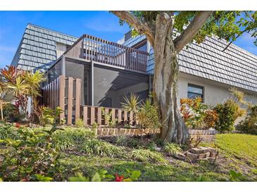 Private screened patio with lush landscaping and deck at 9386 Tradewinds Ave, Seminole, FL 33776