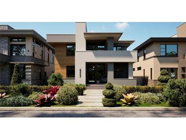 Modern two-story home with gray exterior and landscaped front yard at 4527 26Th S Ave, St Petersburg, FL 33711