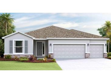 Two-story house with gray siding, two-car garage, and landscaped front yard at 913 160Th E Ln, Bradenton, FL 34212