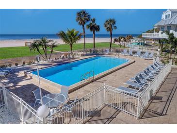 Relaxing community pool with lounge chairs and easy beach access offering an idyllic coastal living experience at 17980 Gulf Blvd # 103, Redington Shores, FL 33708