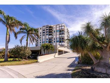 High-rise building with palm trees and parking area at 6372 Palma Del Mar S Blvd # 705, St Petersburg, FL 33715
