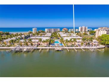 Aerial view of waterfront community with pool and ocean access at 19417 Gulf Blvd # C-211, Indian Shores, FL 33785
