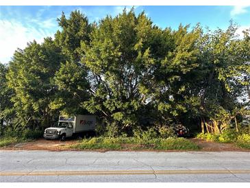 A home partially obscured by lush, mature trees and landscaping at 2733 34Th N Ave, St Petersburg, FL 33713