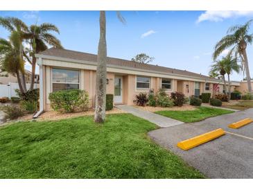 Cute condo with a grassy yard, palm trees, and parking at 6250 7Th W Ave # 6250, Bradenton, FL 34209