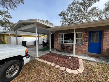 Inviting home exterior featuring a covered carport and well-maintained landscaping at 700 16Th Nw St, Largo, FL 33770