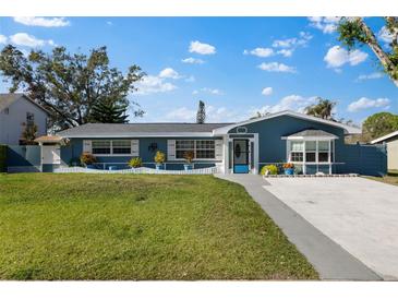 Charming single-story home with a freshly painted exterior and well-manicured lawn at 1730 Audrey Dr, Clearwater, FL 33759