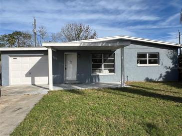 Ranch style home with attached garage and grassy front yard at 4905 Largo Ter, New Port Richey, FL 34652