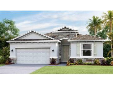 One-story home with stone accents, a two-car garage, and a landscaped lawn at 5719 Silver Feather Way, Palmetto, FL 34221