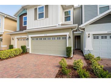 Two story townhome with two-car garage and brick paver driveway at 6356 Camino Dr, Apollo Beach, FL 33572