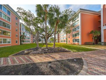 Beautifully landscaped grounds adorn this orange condominium building, providing a serene outdoor setting at 6960 20Th N Ave # 306, St Petersburg, FL 33710