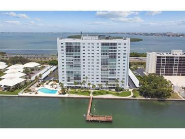 Aerial view of a waterfront highrise building with a pool and private dock at 7200 Sunshine Skyway S Ln # 2A, St Petersburg, FL 33711