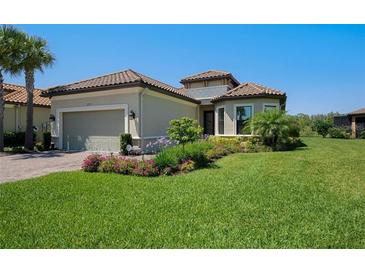 Single-story home with a two-car garage and landscaped yard at 11715 Bitola Dr, Odessa, FL 33556