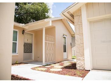 Front entrance of the home with walkway and landscaping at 6741 Willits Ave, New Port Richey, FL 34655