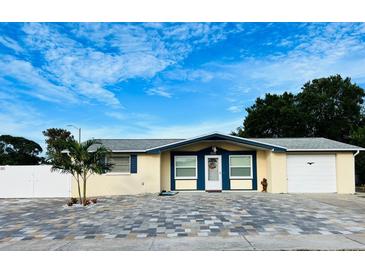 Inviting single-story home with a paved driveway and well-manicured lawn at 11511 Meredith Ln, Port Richey, FL 34668