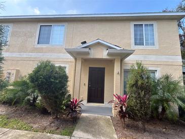 Inviting exterior showcasing a well-maintained two-story townhome with a beautifully landscaped front yard at 10812 Brickside Ct, Riverview, FL 33579