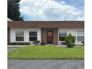 Charming single-story condo with well-maintained lawn and neutral exterior paint at 6177 Chesham Dr # 6, New Port Richey, FL 34653